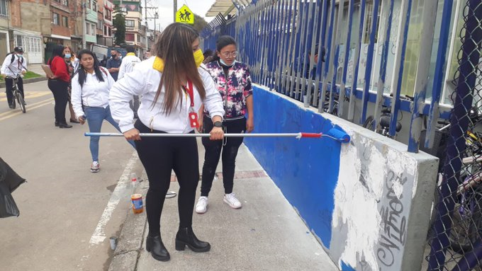foto de funcionaria pintando pared
