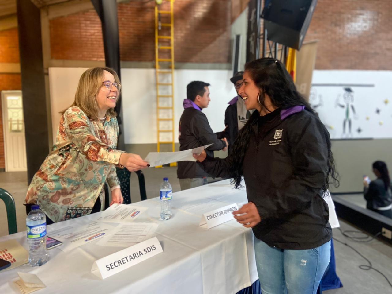 foto de secretaria entregando diploma