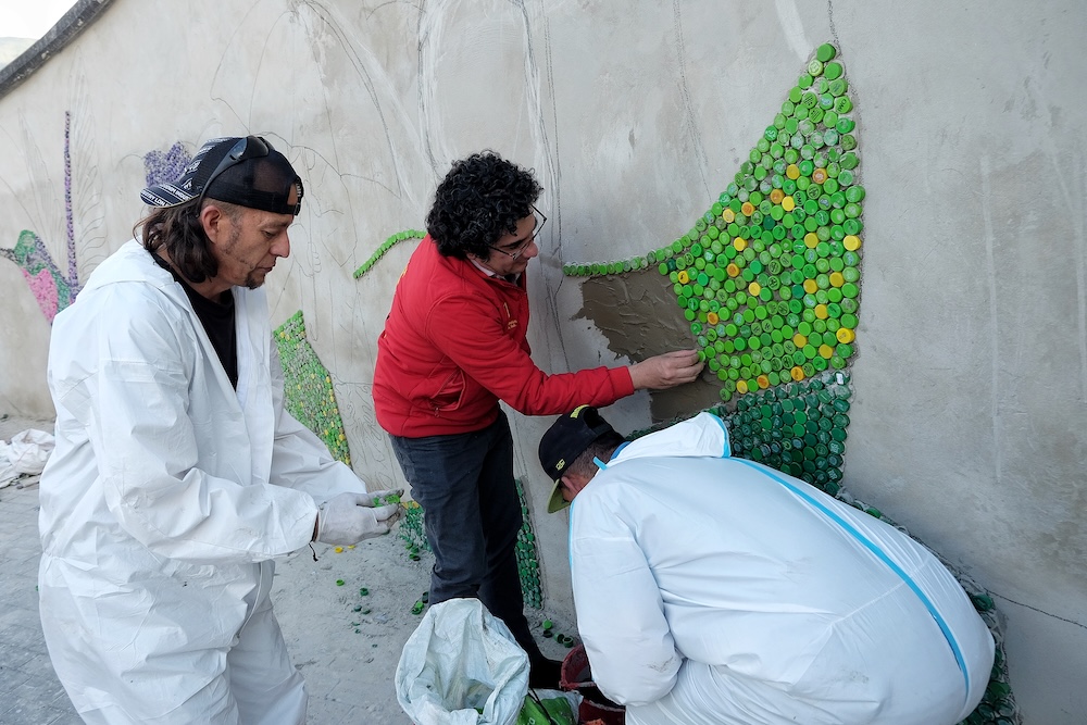 foto secretario ayudando a pegar tapas en el mural